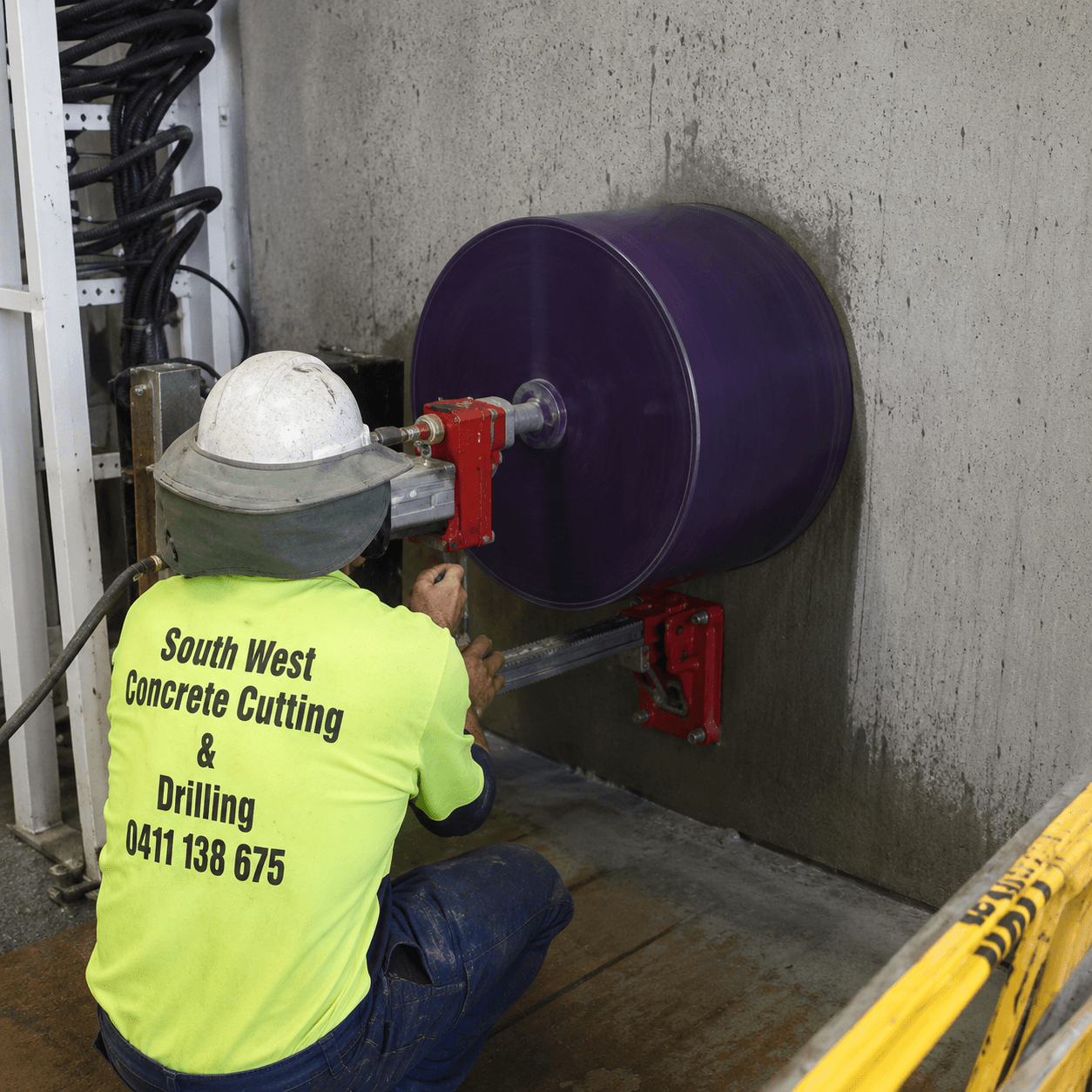 Concrete core drilling through slab wall.