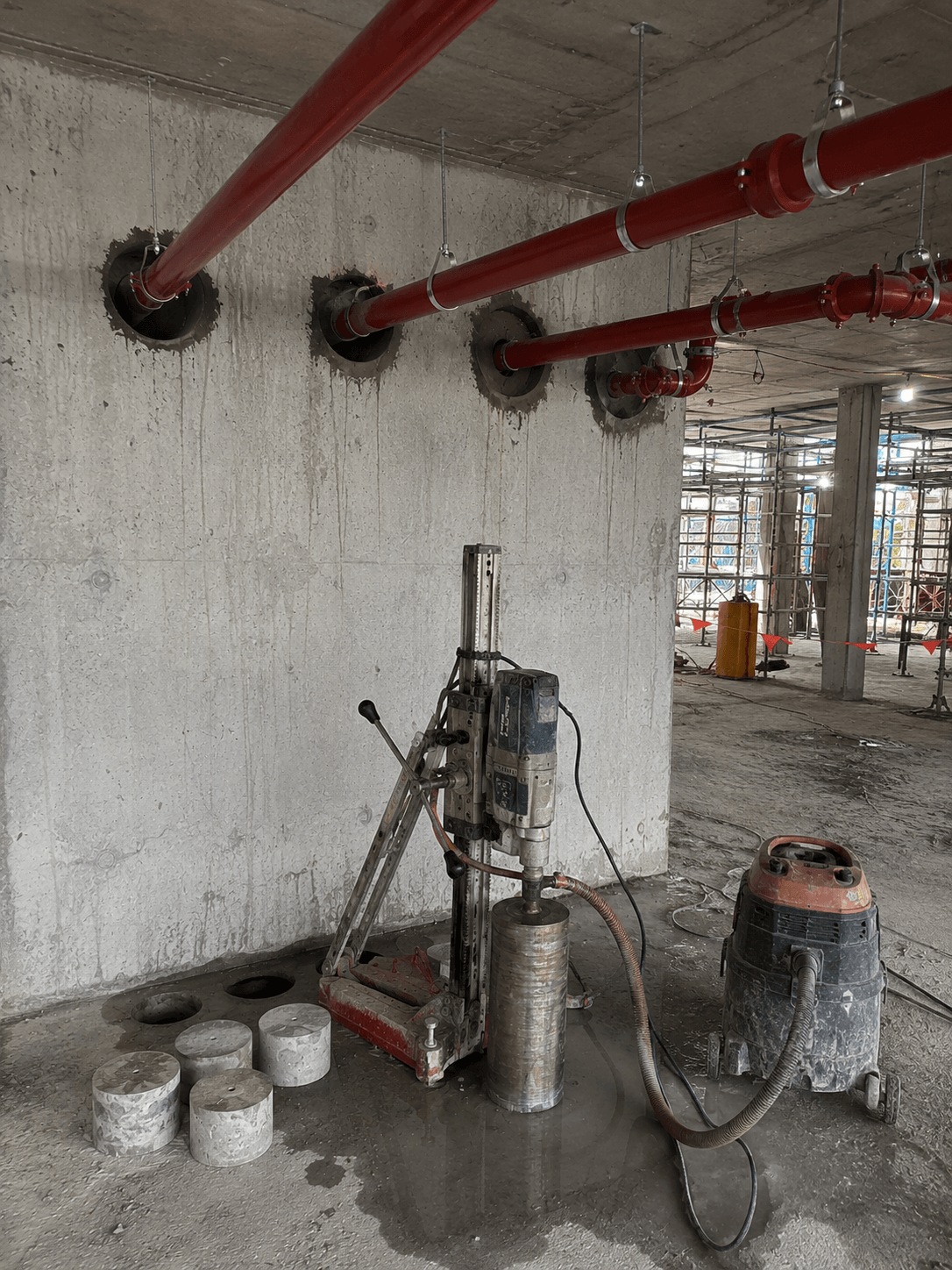 Concrete core drilling for fire service penetrations and sprinkler installation.